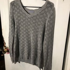 A grey knitted crew neck sweatshirt